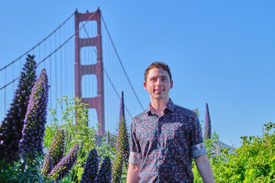 A picture of Tommaso standing in front of the Golden Gate Bridge.